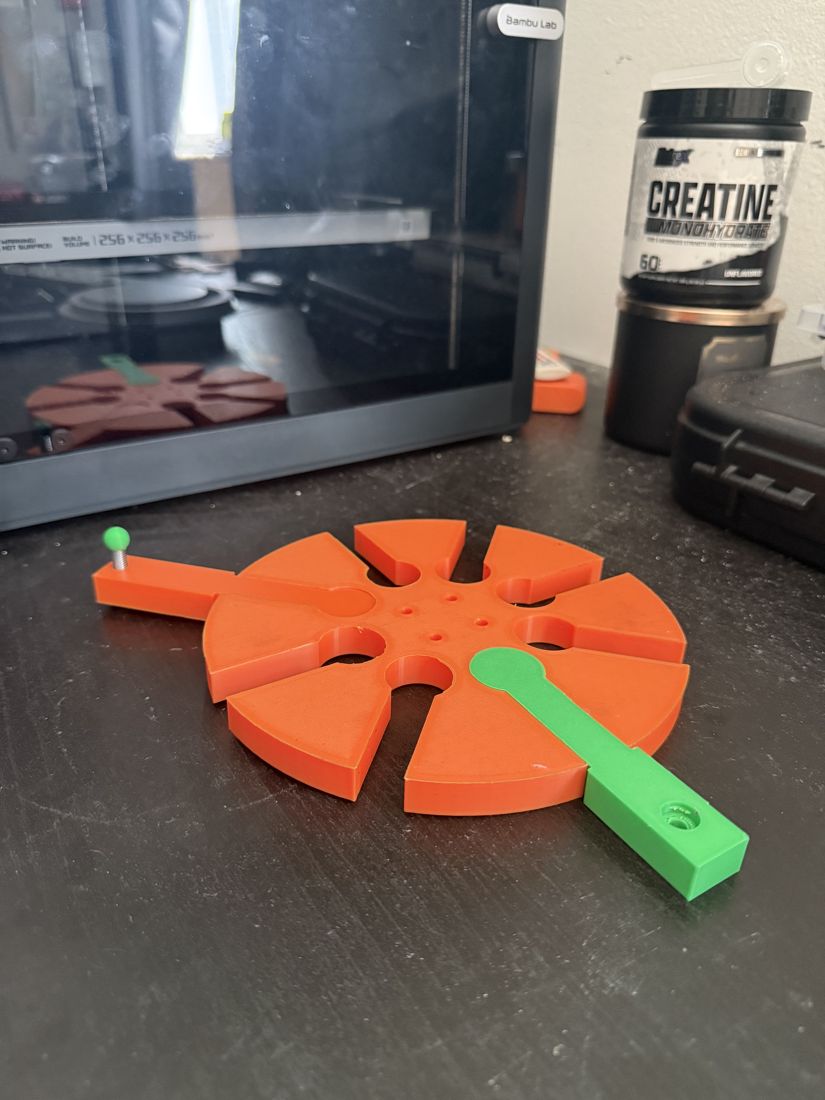 Printed V1 hub with arm test-fit, resting on the bench