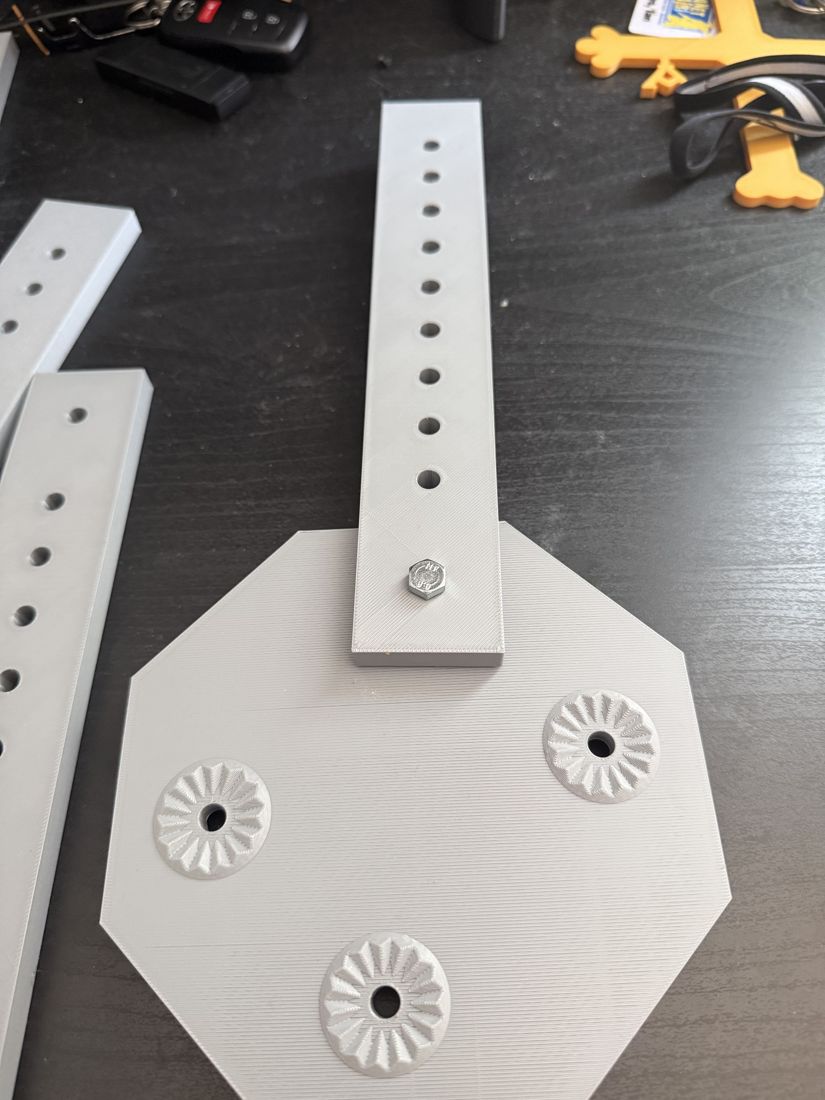 Perforated rail bolted to the octagonal base plate, full assembly view