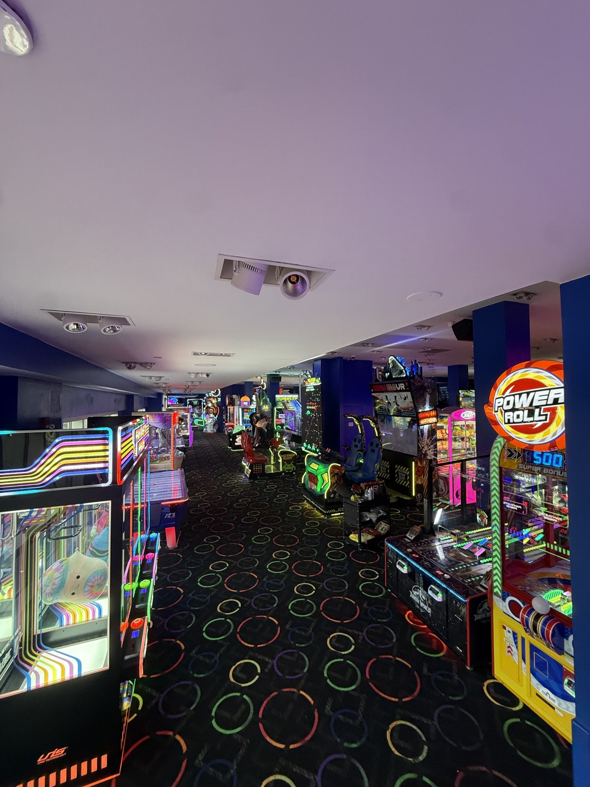 Row of arcade cabinets on the floor