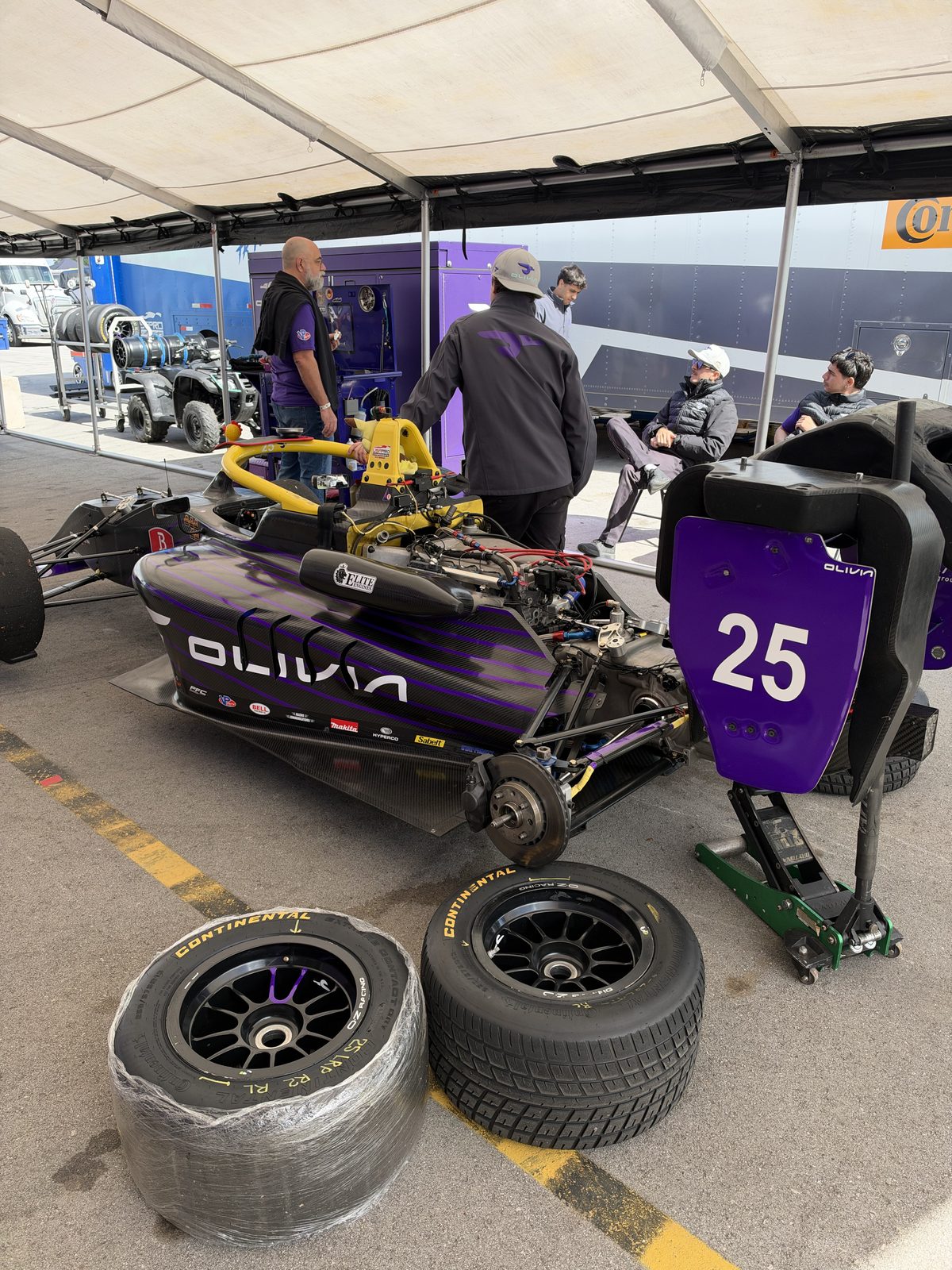 Tire sets staged next to the car in the paddock
