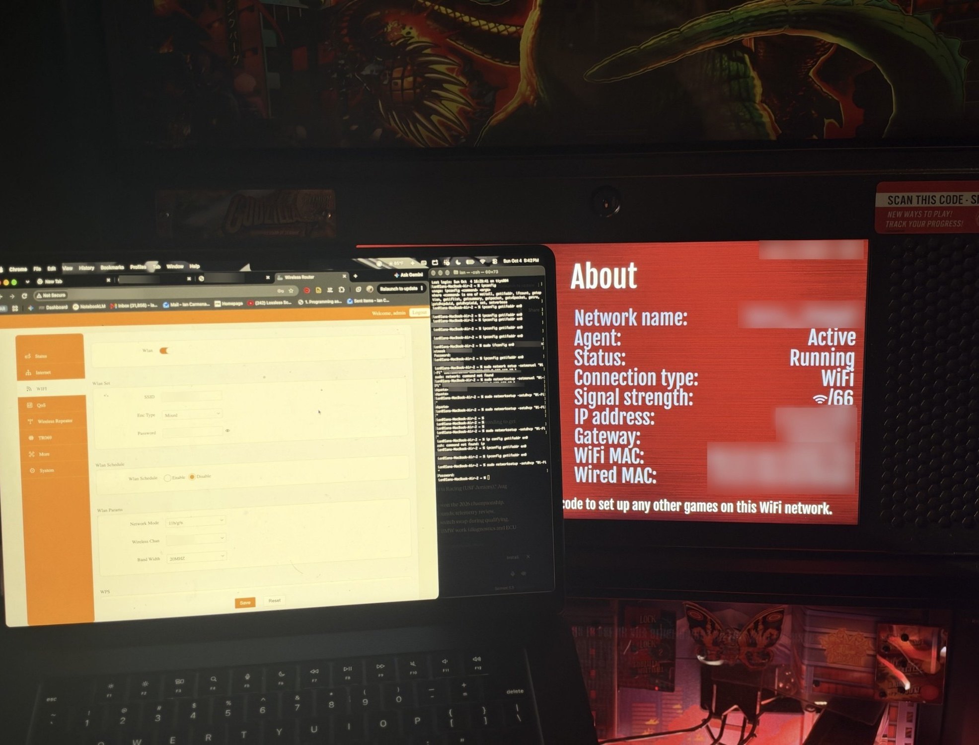 Laptop with the router settings and Terminal open next to a Stern machine's network About screen